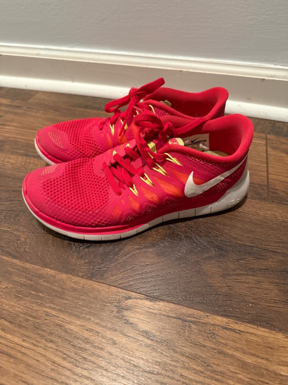 Nike Free 5.0 women's running shoes in a red and volt colorway.